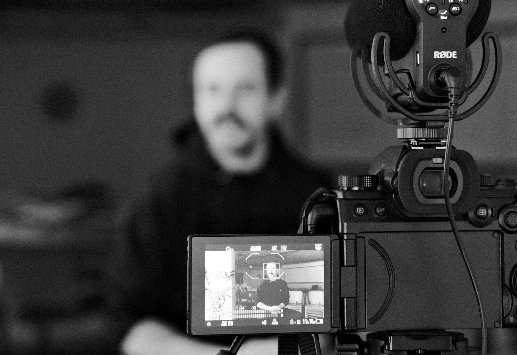 View of a camera on a tripod with the subject blurred